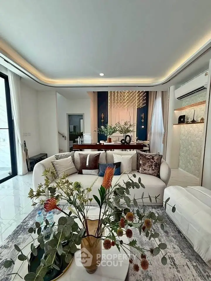 Luxurious living room with elegant decor and modern furniture, featuring a stylish open layout and ambient lighting.