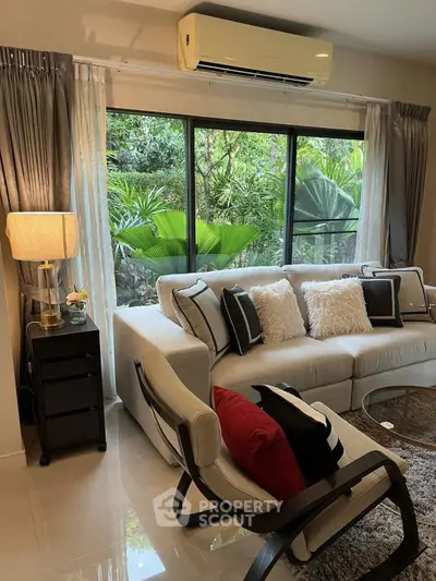 Stylish living room with modern furniture and lush garden view