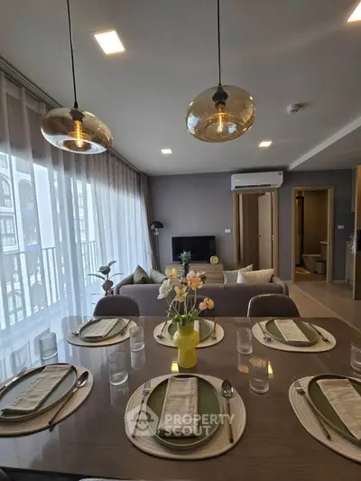Modern living room with elegant dining setup and stylish lighting