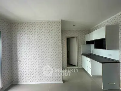 Modern kitchen with sleek cabinetry and floral wallpaper in a bright, open space.