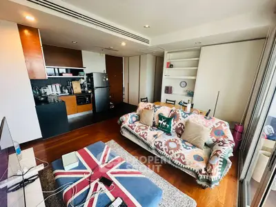 Stylish living room with modern kitchen and unique decor in open layout apartment.