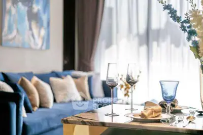 Elegant living room with blue sofa and stylish dining setup, perfect for modern living.