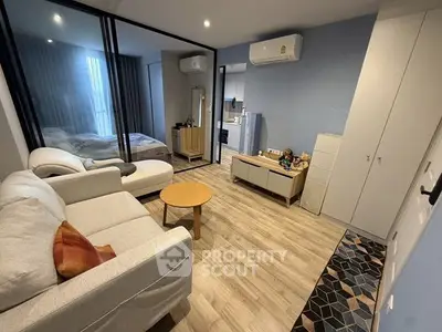Modern living room with stylish decor and cozy bedroom view