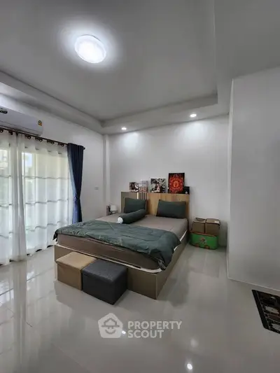 Spacious modern bedroom with elegant decor and natural light