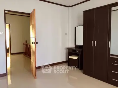 Spacious bedroom with wooden furniture and polished floors