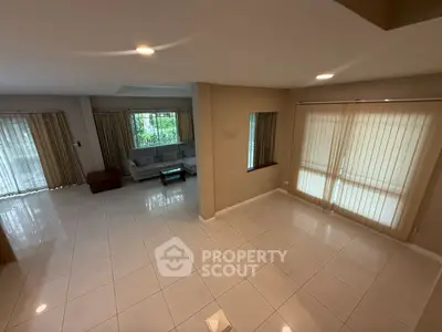 Spacious living room with modern design and large windows for natural light.