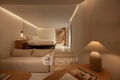 Luxurious modern bedroom with cozy living area and ambient lighting