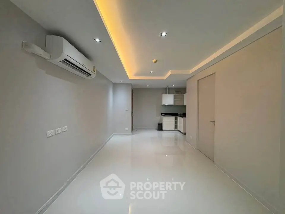 Modern minimalist apartment interior with sleek lighting and air conditioning.