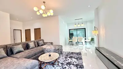 Spacious modern living room with elegant decor and open dining area