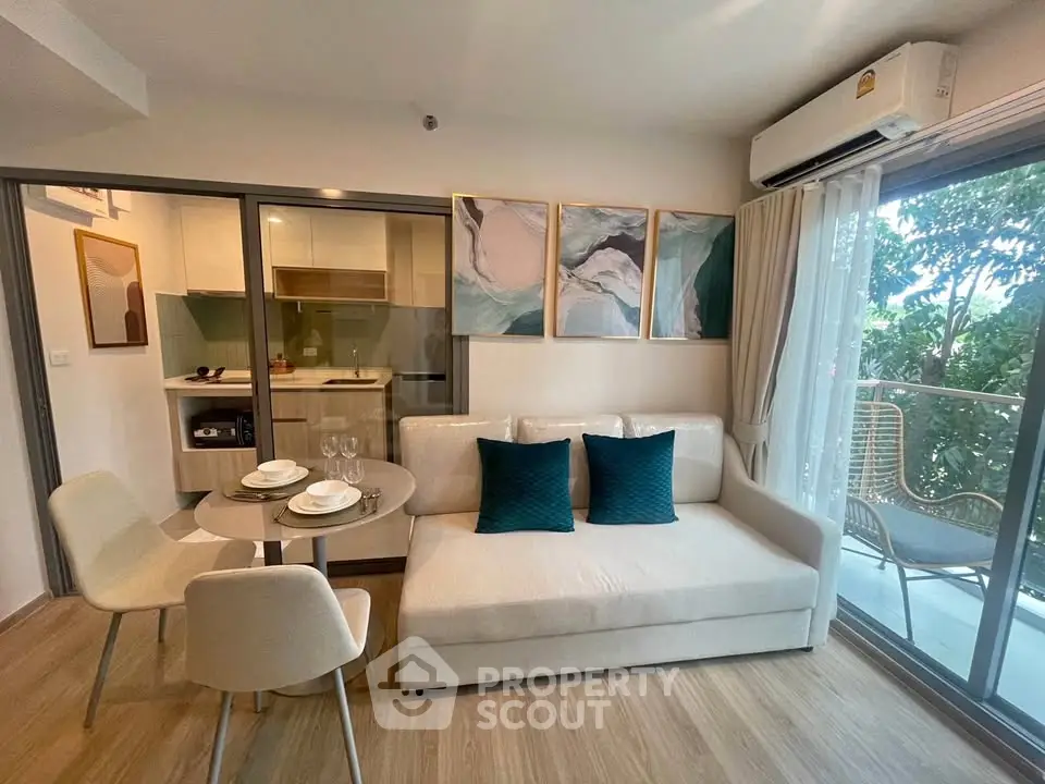 Modern living room with open kitchen and balcony view