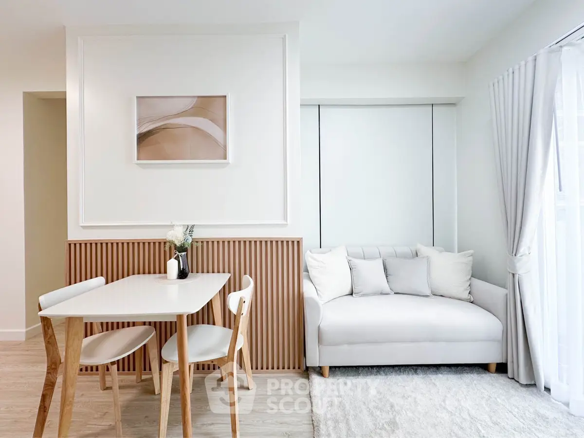 Modern living room with elegant dining set and cozy sofa, perfect for stylish urban living.