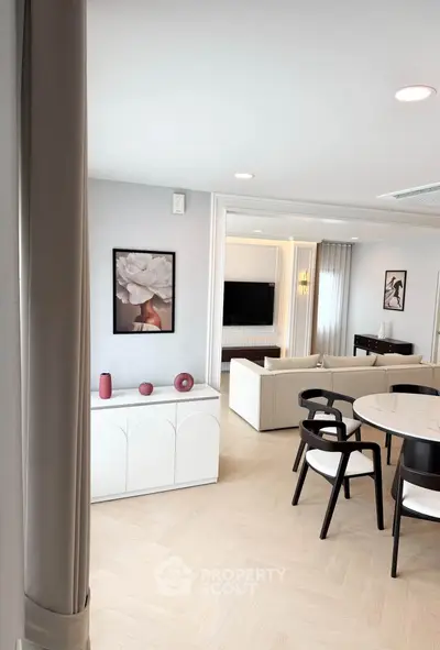 Elegant modern living room with stylish decor and open layout, featuring chic furniture and contemporary artwork.