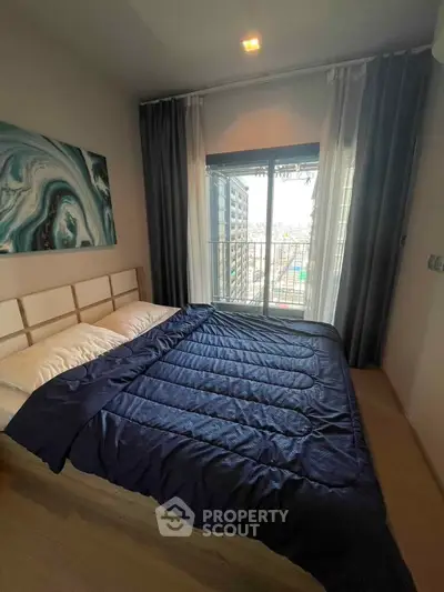 Cozy bedroom with large window and modern decor in urban apartment