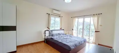 Spacious bedroom with large windows and modern decor