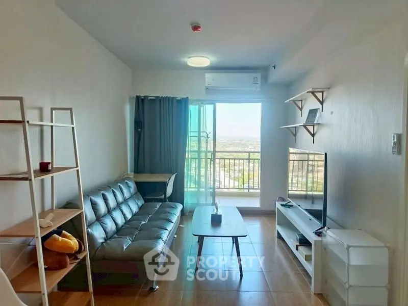 Modern living room with balcony view, stylish furniture, and natural light.