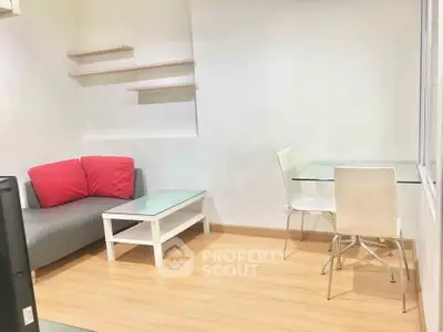 Cozy living room with modern furniture and wooden flooring, perfect for relaxation and entertaining.