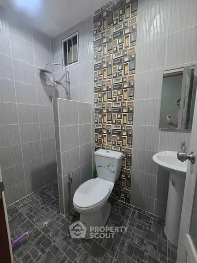 Modern bathroom with stylish tile design and compact layout