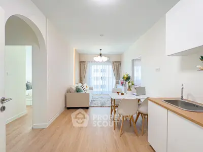 Modern open-plan living and dining area with stylish decor and natural light.