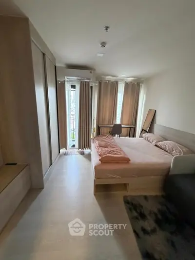 Modern bedroom with balcony access and stylish decor in urban apartment