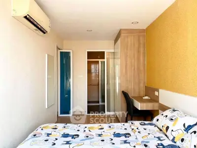 Cozy bedroom with modern decor and ample natural light, featuring a stylish desk and built-in wardrobe.