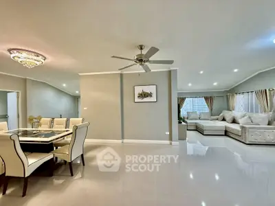 Spacious modern living room with elegant dining area and luxurious seating, perfect for entertaining.