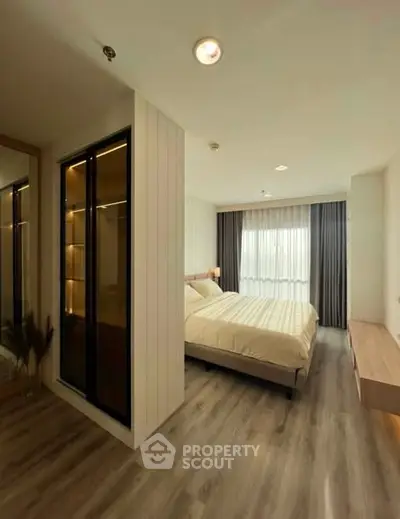 Modern bedroom with elegant wooden flooring and ample natural light