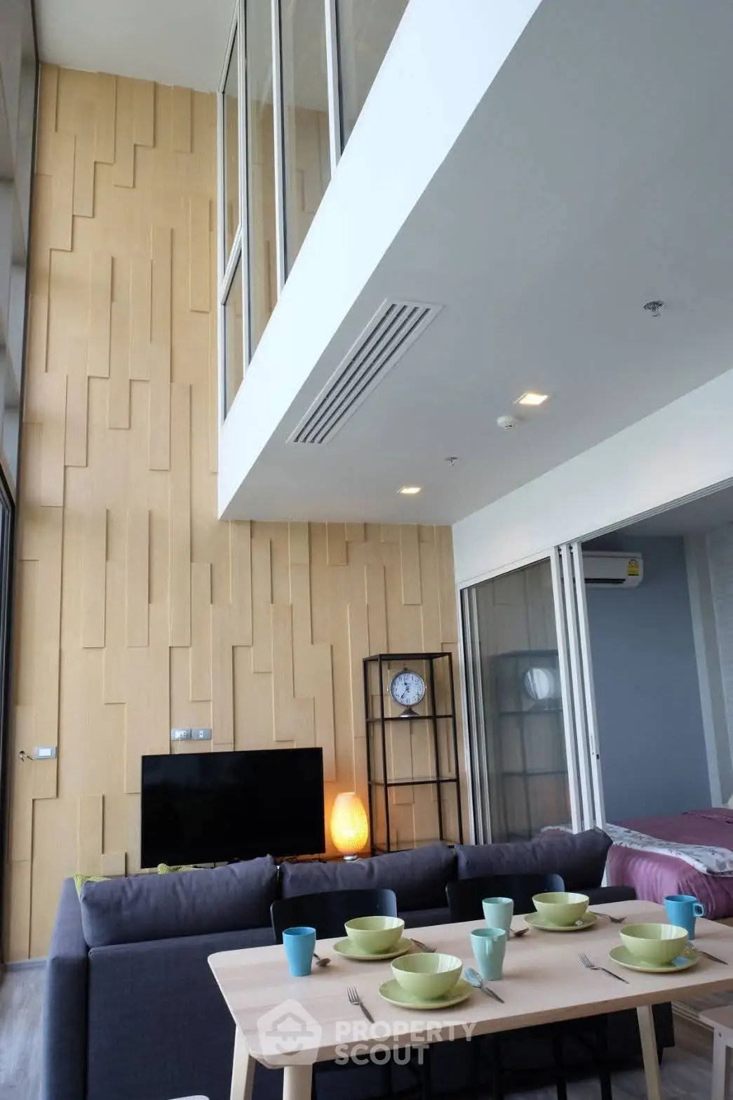 Modern living room with high ceiling and stylish decor in a contemporary apartment