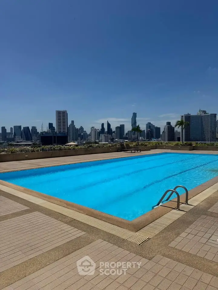 Stunning rooftop pool with panoramic city skyline views, perfect for luxury urban living.