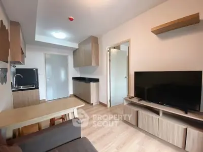 Modern living room with sleek furniture and open kitchen layout