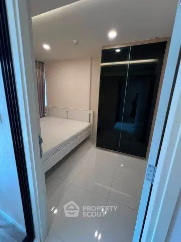 Modern bedroom with sleek wardrobe and glossy floor tiles