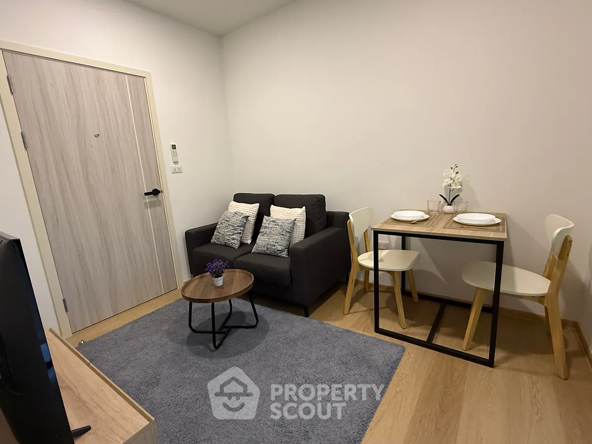 Cozy modern living room with stylish furniture and dining area, perfect for urban living.