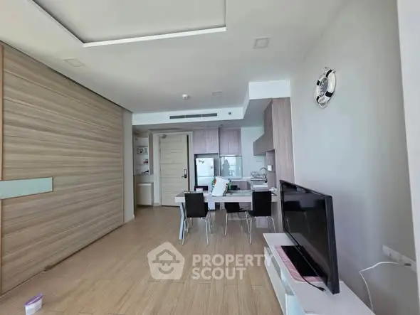 Modern open-plan living room with dining area and sleek kitchen design.