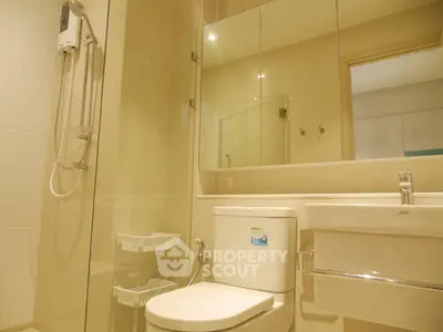 Modern bathroom with glass shower and sleek fixtures in a contemporary home.