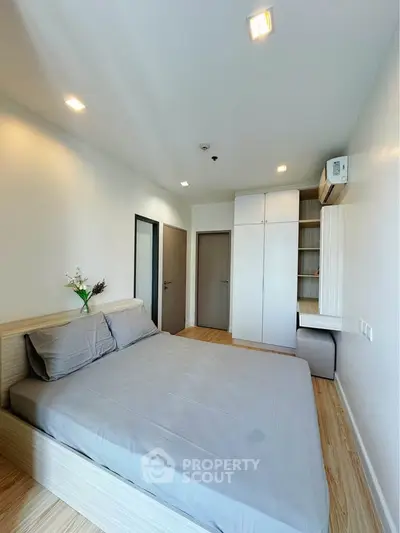 Modern bedroom with sleek design, built-in wardrobe, and cozy atmosphere in a stylish apartment.