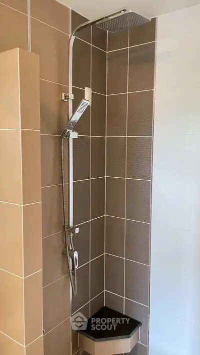 Modern bathroom shower with sleek design and neutral tiles, perfect for contemporary homes.