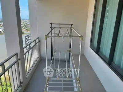 Spacious balcony with city and river view, perfect for relaxation and enjoying the scenery.