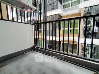 Modern balcony with sleek railing and urban view in contemporary apartment complex