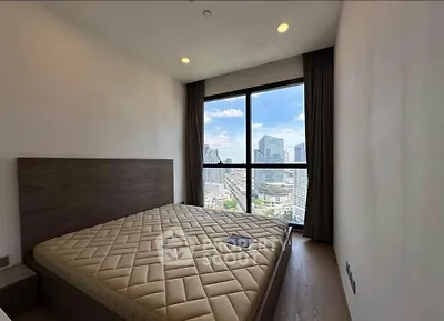 Modern bedroom with stunning city view from large window, featuring a minimalist design and cozy atmosphere.