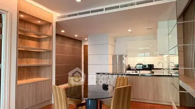 Modern kitchen with sleek design, open layout, and stylish dining area in a contemporary apartment.
