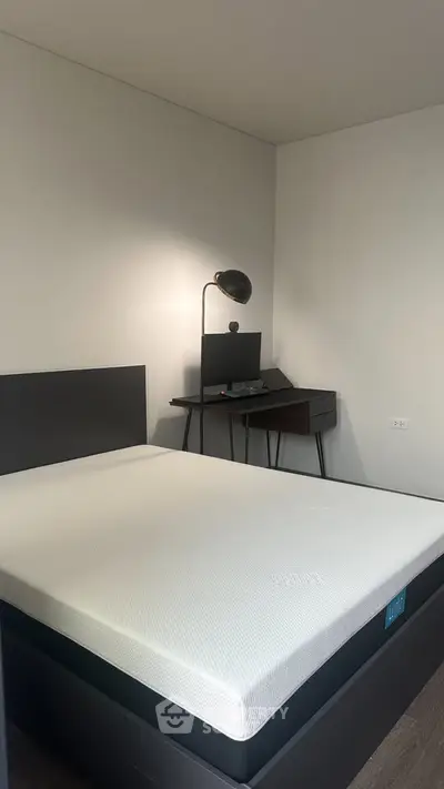 Modern bedroom with sleek desk and minimalist design.