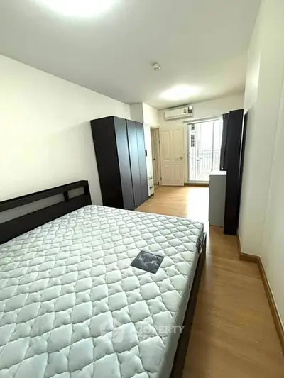 Spacious bedroom with modern furnishings and ample natural light