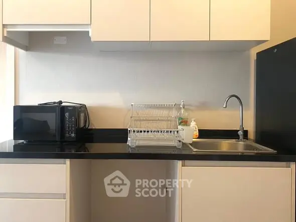 Modern kitchen with sleek cabinetry and countertop appliances