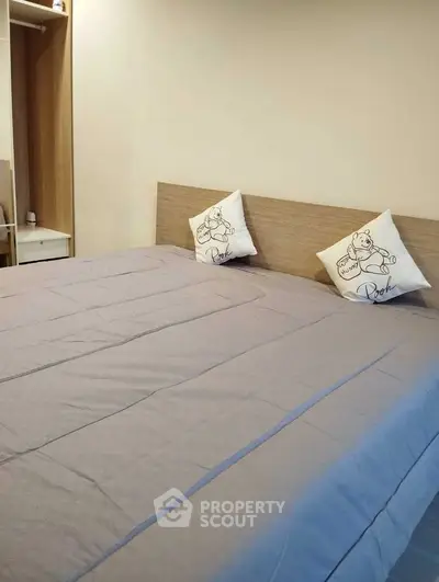 Cozy bedroom with stylish bedding and decorative pillows, perfect for relaxation and comfort.