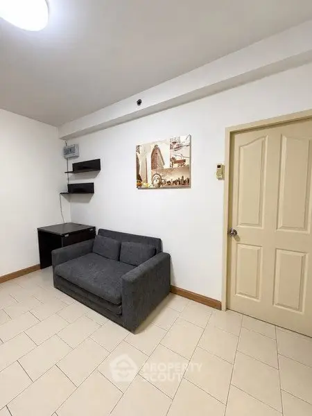 Cozy living room with modern sofa and wall art in a minimalist design.