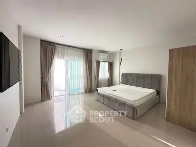 Spacious bedroom with modern design and large windows for natural light
