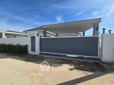 Modern gated entrance of a stylish home with clean lines and contemporary design.