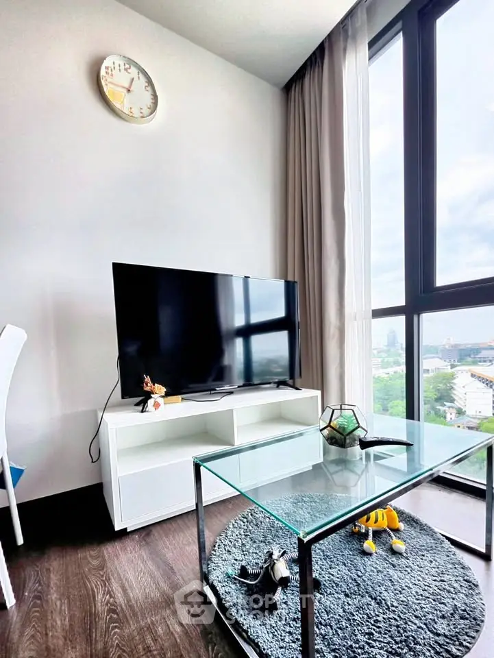 Modern living room with large window and sleek TV setup