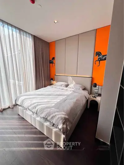 Modern bedroom with stylish decor and floor-to-ceiling windows