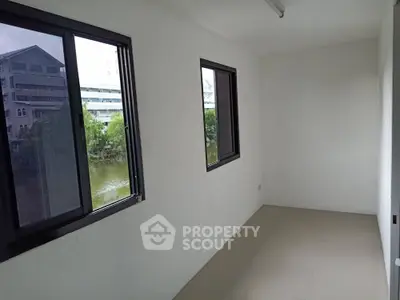 Spacious empty room with large windows offering serene river view