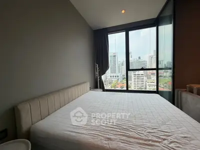 Modern bedroom with city view in high-rise apartment